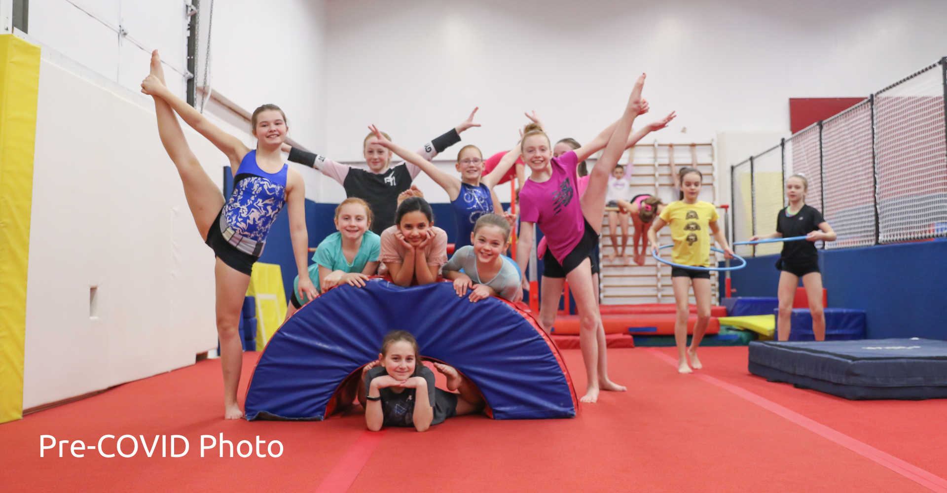 A group of young gymnasts striking group pose at Gymworld Adventures in Gymnastics in Northwest London, Ontario