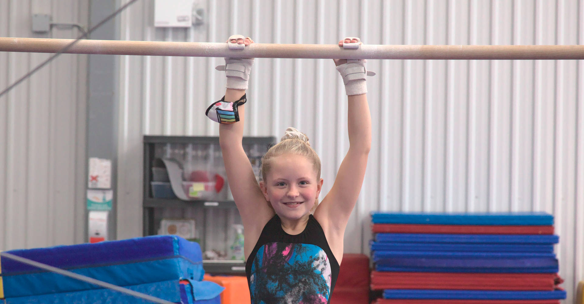 A smiling gymnast prepares for her routine on the bars at the Gymworld Adventures in Gymnastics facility in London Ontario
